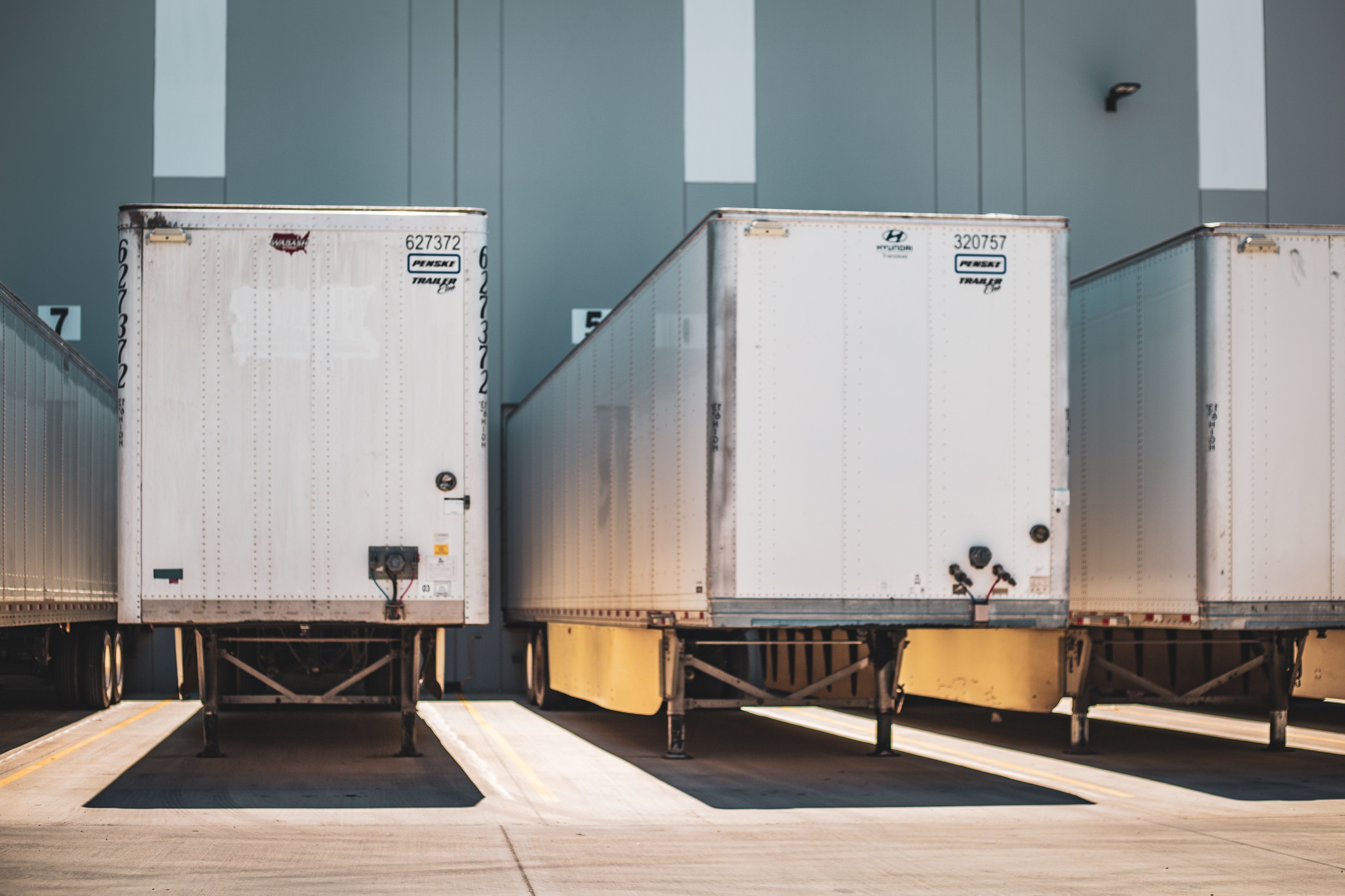 Image Commercial truck trailers parked at a loading dock, illustrating negligent hiring by a freight broker in Philadelphia truck accident claims.