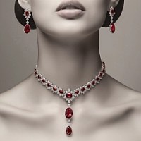 A woman wearing a stunning rubies and diamonds necklace.