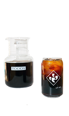 Toddy® Cold Brew System with coffee and glass can.