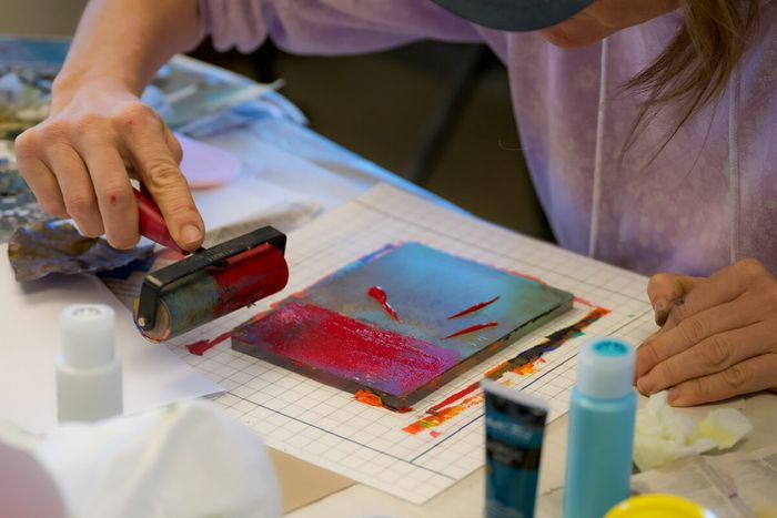 Image of student applying ink to block
