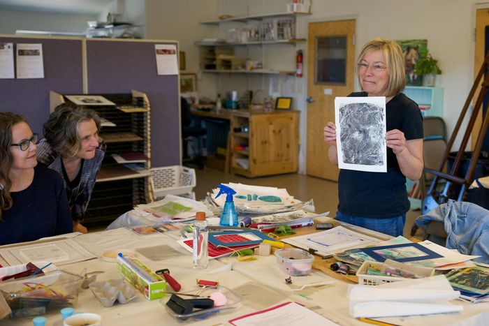 Image of instructor Loretta Columbia showing students the process