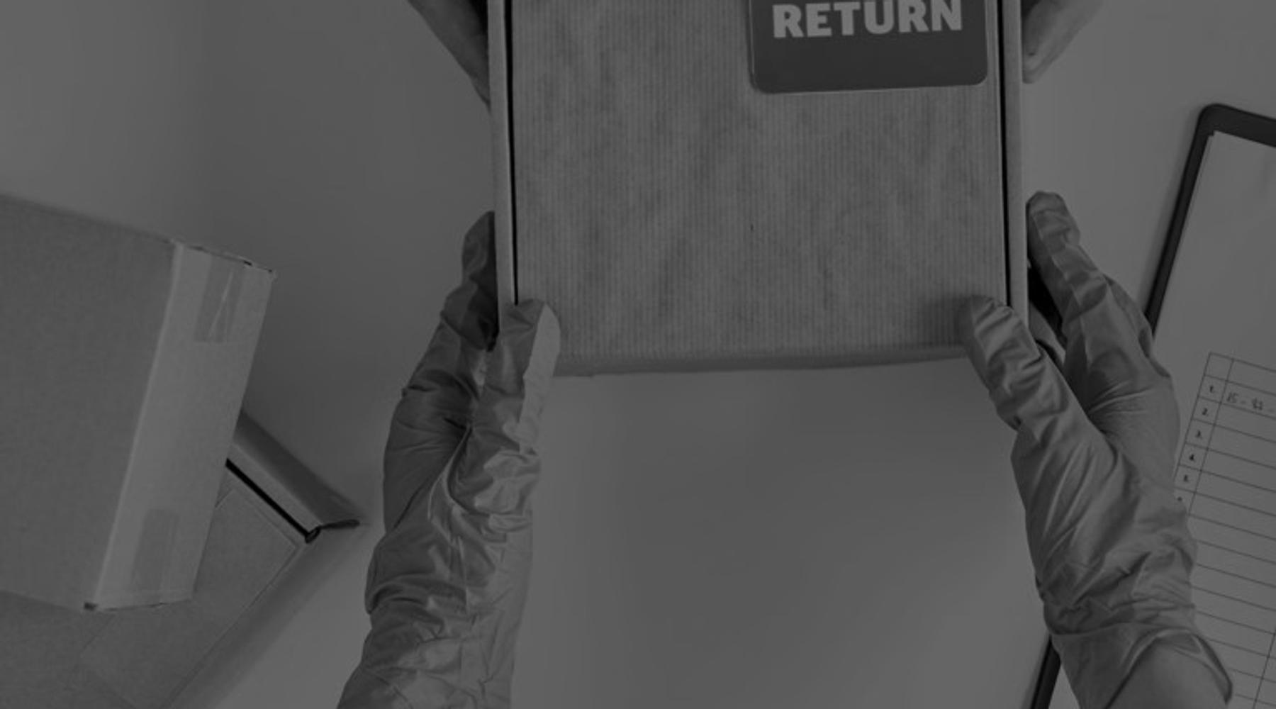 Photograph of two people handling a shipping box labeled “RETURN,” with one pair of hands wearing protective gloves and another holding the package, representing logistics, warehousing, and reverse distribution operations.