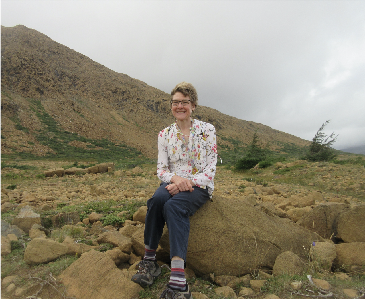 Bjornerud sitting on mantle rock at Table Mountain in Newfoundland, Canada. (Courtesy Marcia Bjornerud)