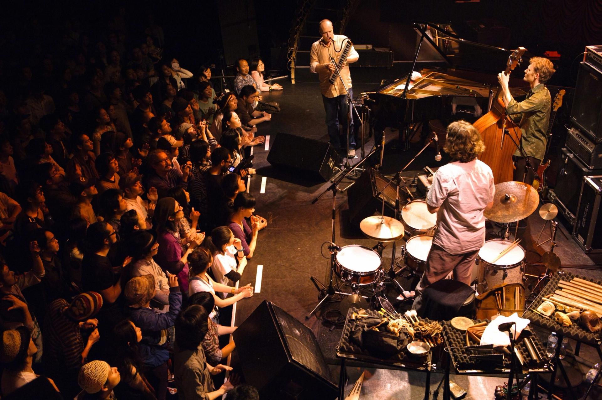 John Medeski (top), Chris Wood (right), and Martin (bottom) on stage. (Courtesy Billy Martin)