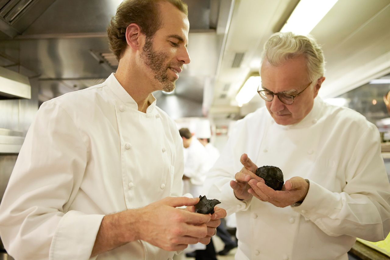 Barber inspecting a black truffle with French chef Alain Ducasse in the Blue Hill kitchen in 2012. (Photo: Thomas Delhemmes. Courtesy Dan Barber)