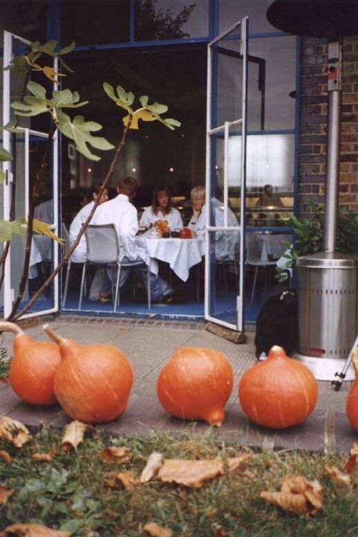 Rogers (center), Gray (right), and two of their team members sitting at one of the window tables at the River Cafe. (Courtesy The River Cafe)