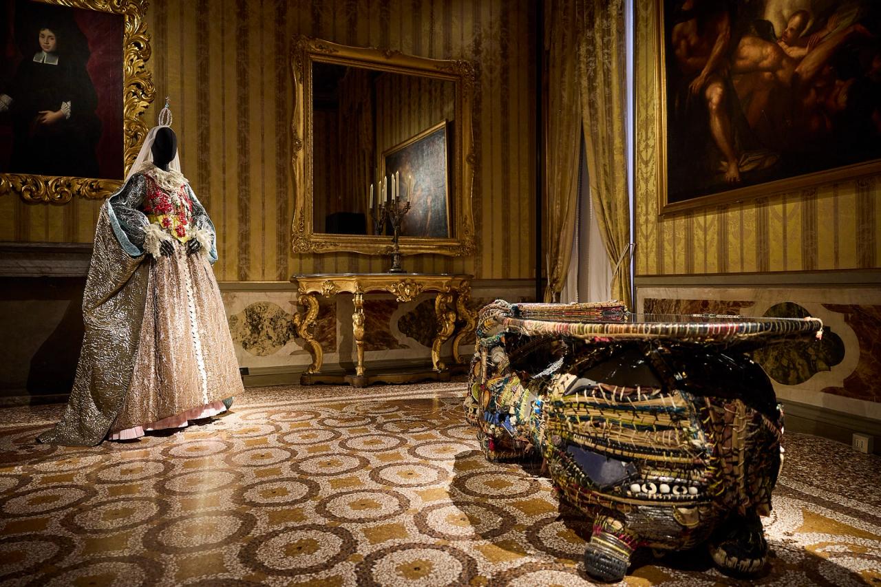 View of Room 14. From left: Christian Lacroix headdress arranged by Fabio Petri (haute couture fall/winter 2001) and Misha Kahn’s “An Uncertain Task” (2018). (Photo: Antonio Campanella for The Slowdown/Courtesy Christian Lacroix, STL group; Courtesy Friedman Benda and Misha Kahn)