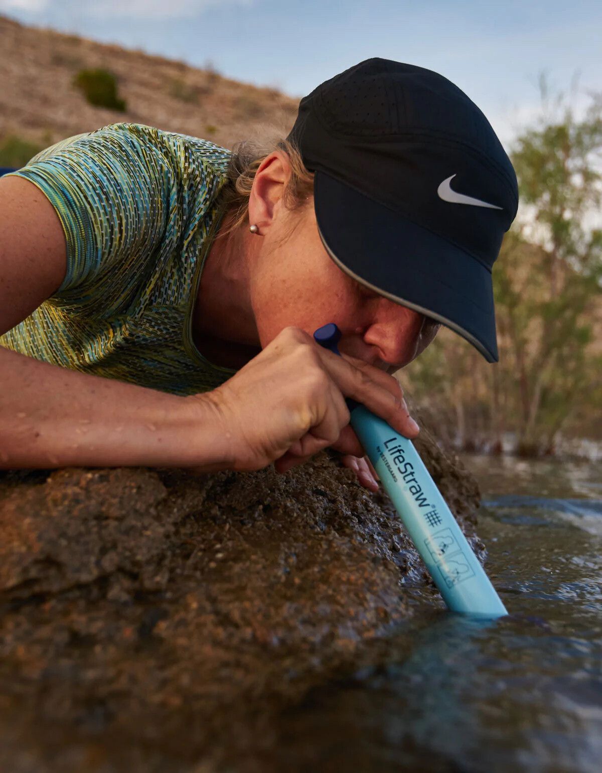 Australian businesswoman Mina Guli using a LifeStraw personal water filter. (Courtesy LifeStraw)