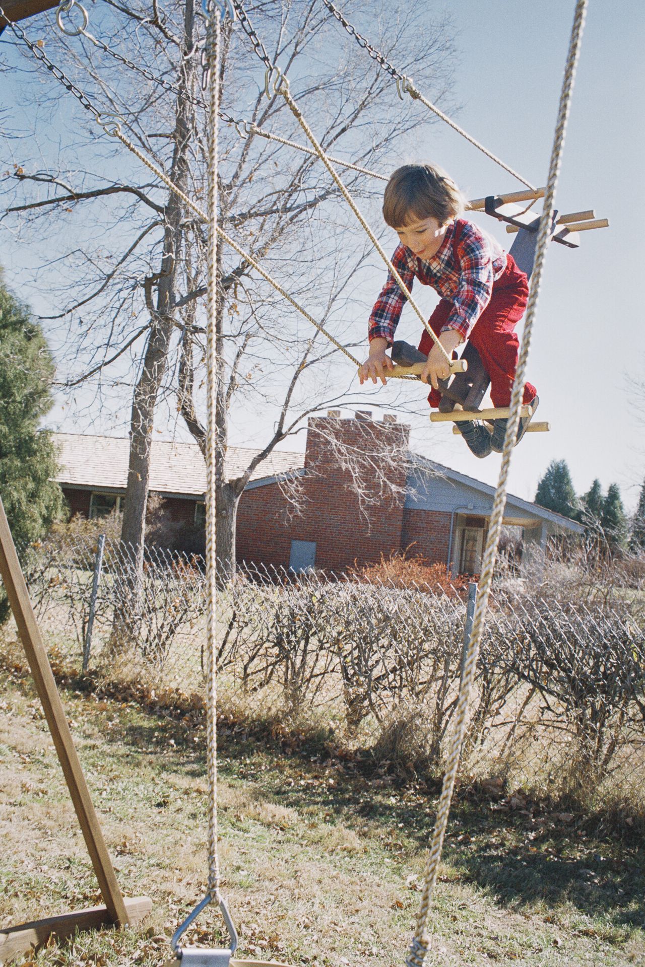 Bailey’s older brother, Brandon, on the swing set in the backyard of the family’s Bow Mar, Colorado, home.