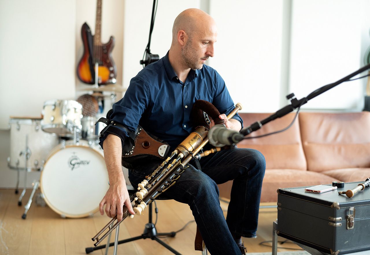 Adamson playing the Irish pipes in The Slowdown recording studio. (Courtesy Andrew Zuckerman)