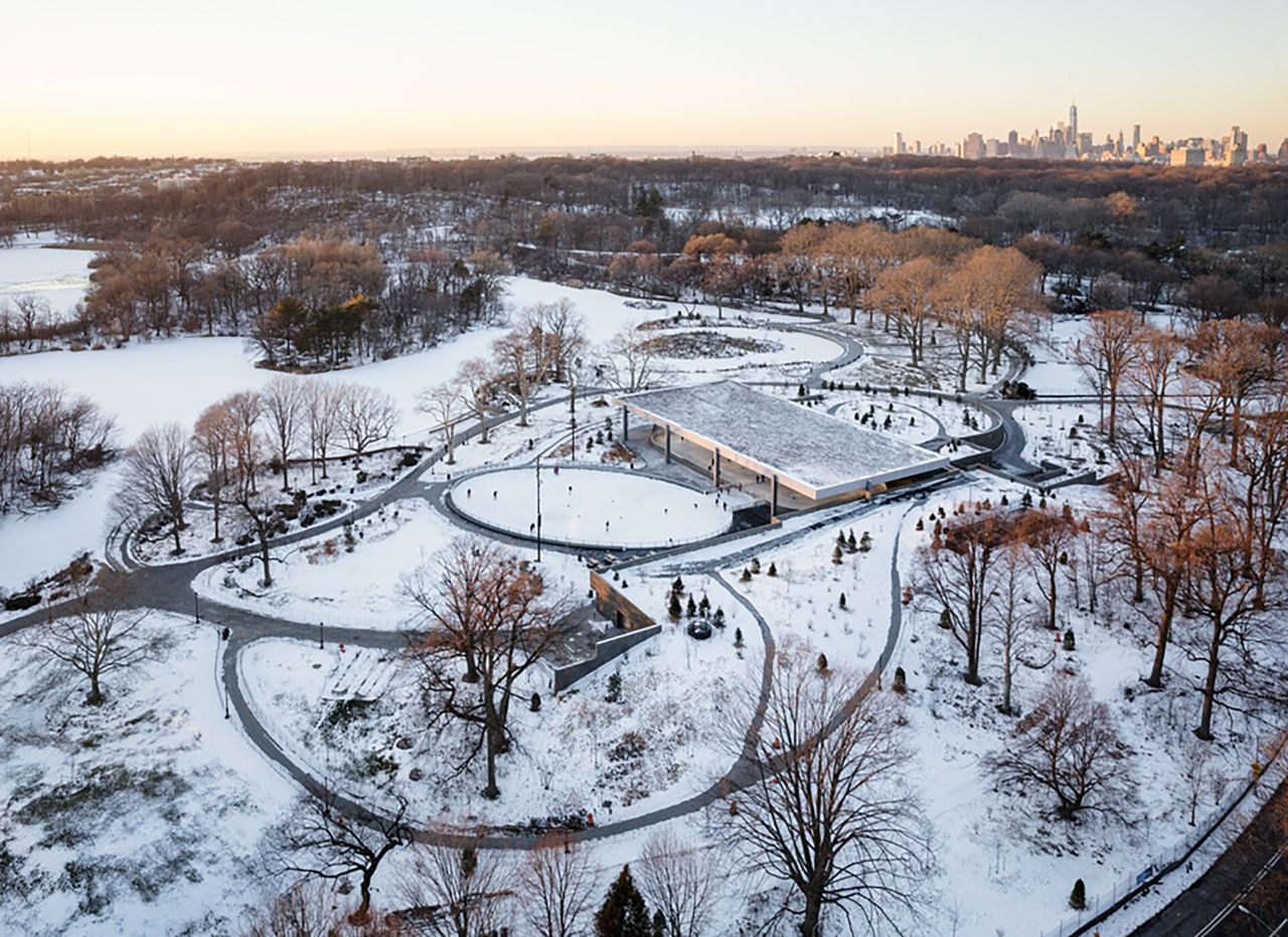 An overhead view of a park with circular pathways in the snow