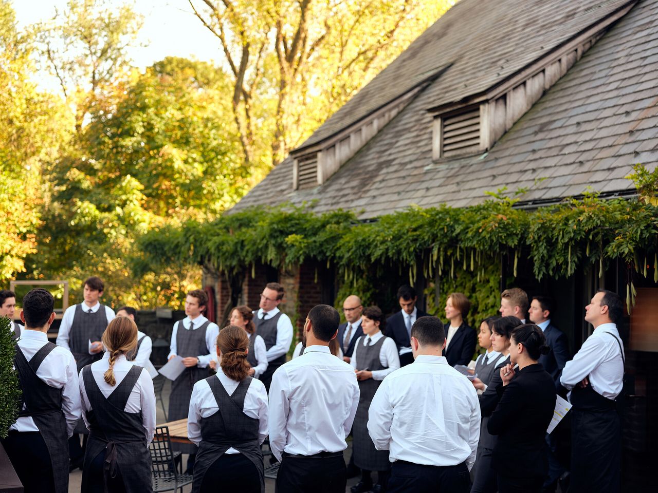 A front of house pre-service meeting on the terrace at Blue Hill at Stone Barns. (Photo: Alice Gao. Courtesy Blue Hill)