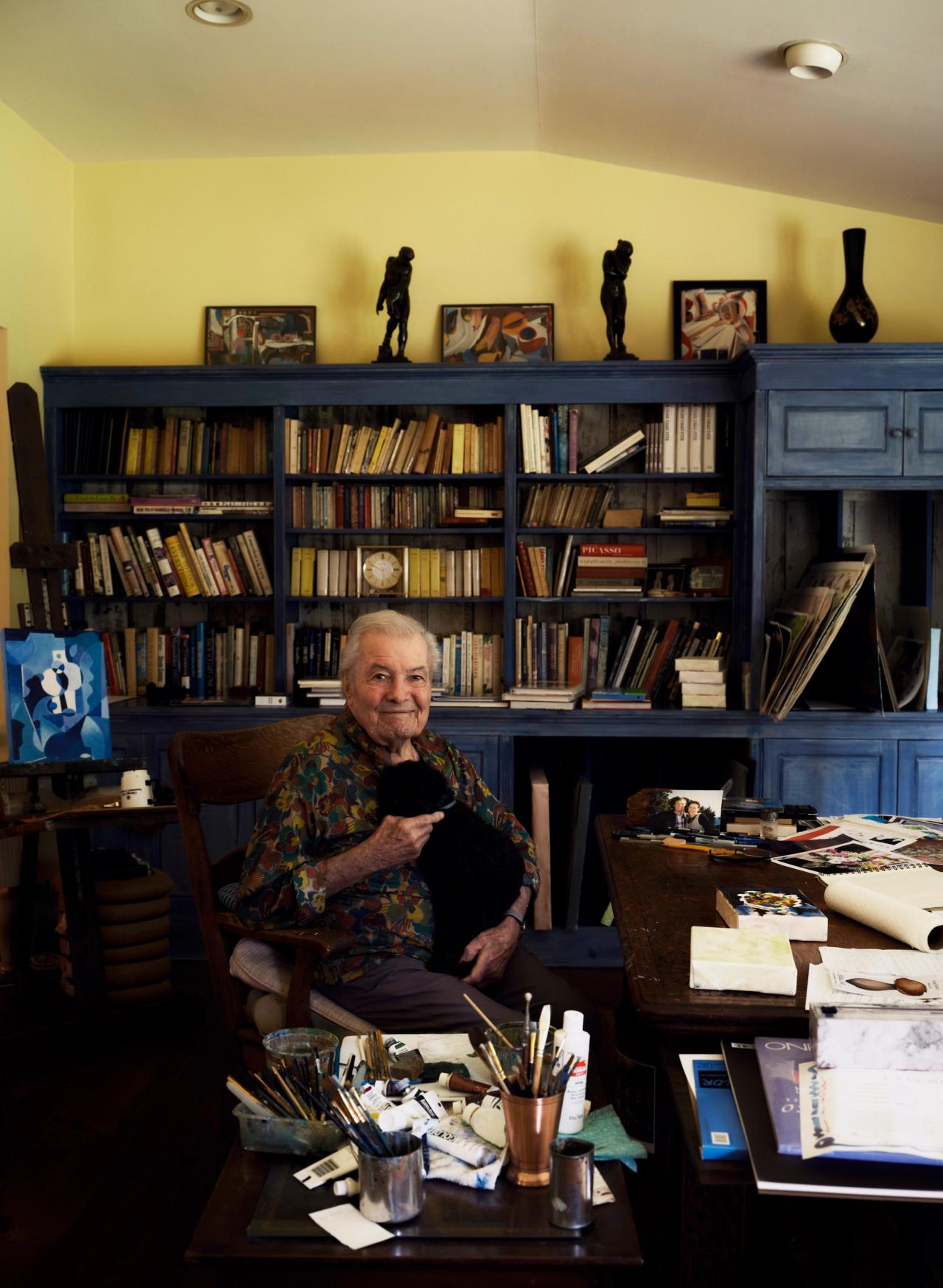 Jacques Pépin with his dog, Gaston, inside his painting studio at his home in Madison, Connecticut. (Photo: Matthew Harrington for The Slowdown)