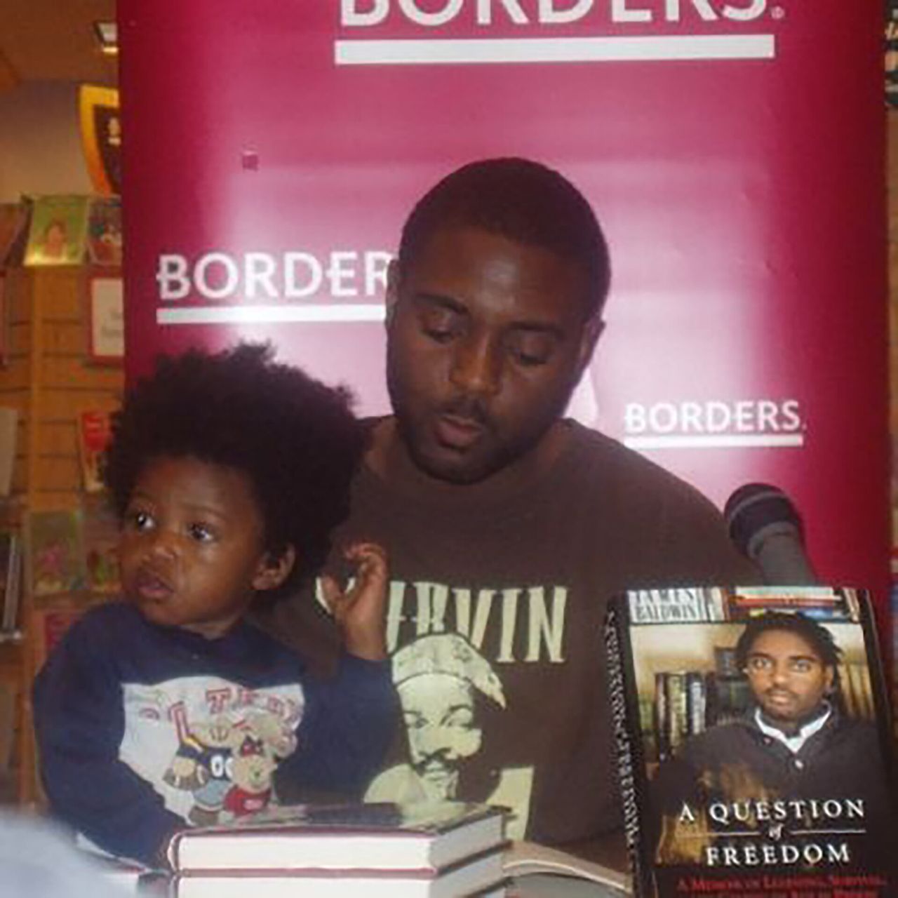 Betts and his son Micah at a book signing for A Question of Freedom in 2010. (Courtesy Reginald Dwayne Betts)