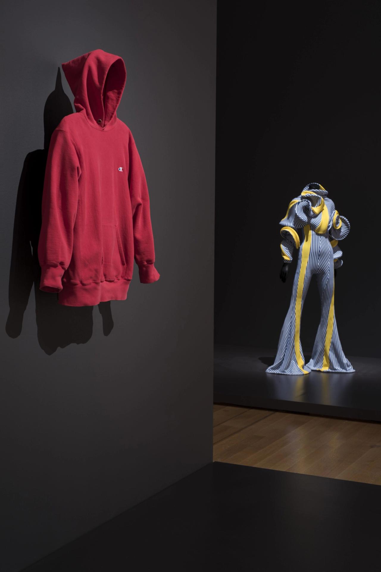 A red Champion hoodie, as presented in the MoMA exhibition "Items: Is Fashion Modern?" (2017–2018). (Photo: Martin Seck. © The Museum of Modern Art/Licensed by SCALA / Art Resource, NY)