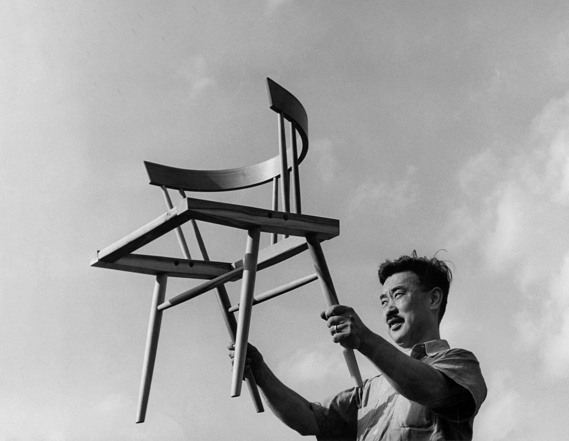 George with a chair in the style of the Michener Museum reading room furniture. (Courtesy George Nakashima Woodworkers)