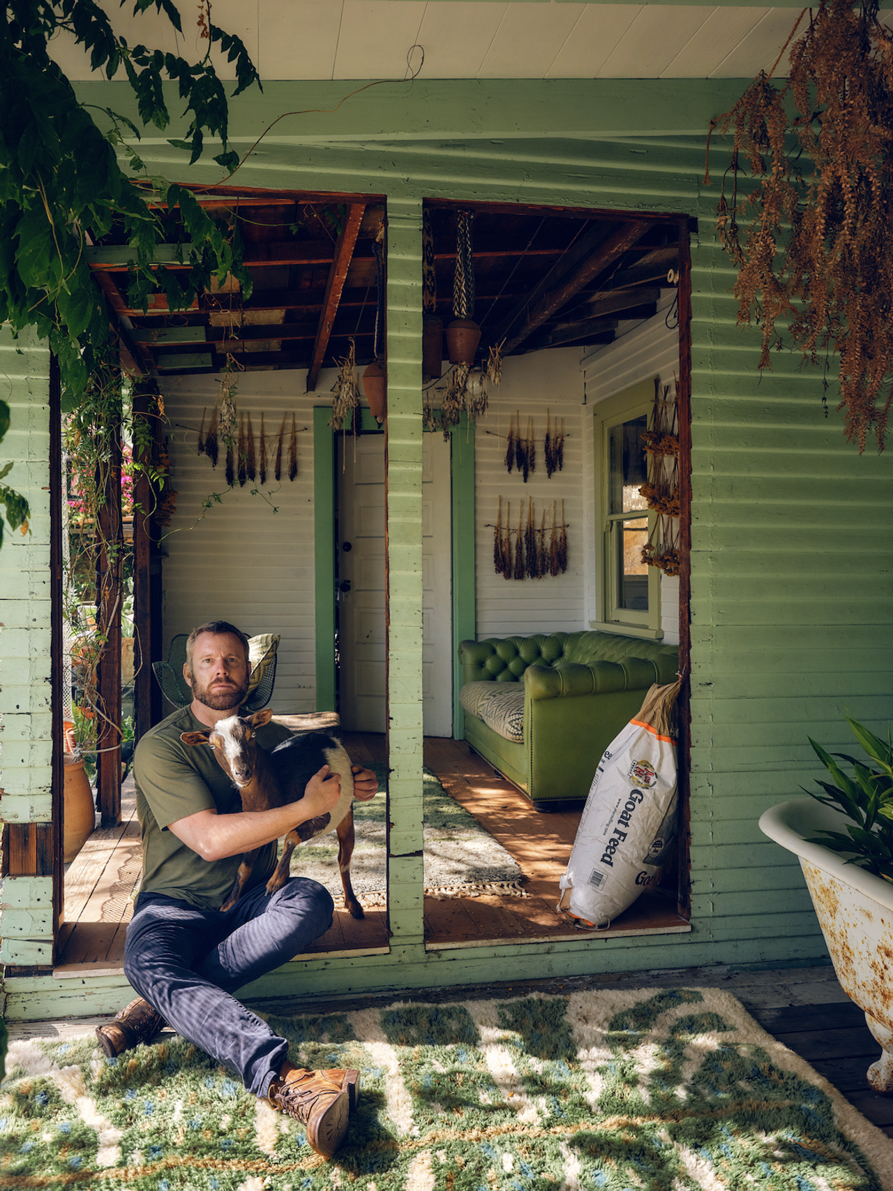 Christiansen at home with one of his goats. (Photo: Hugh Davison. Courtesy Flamingo Estate)
