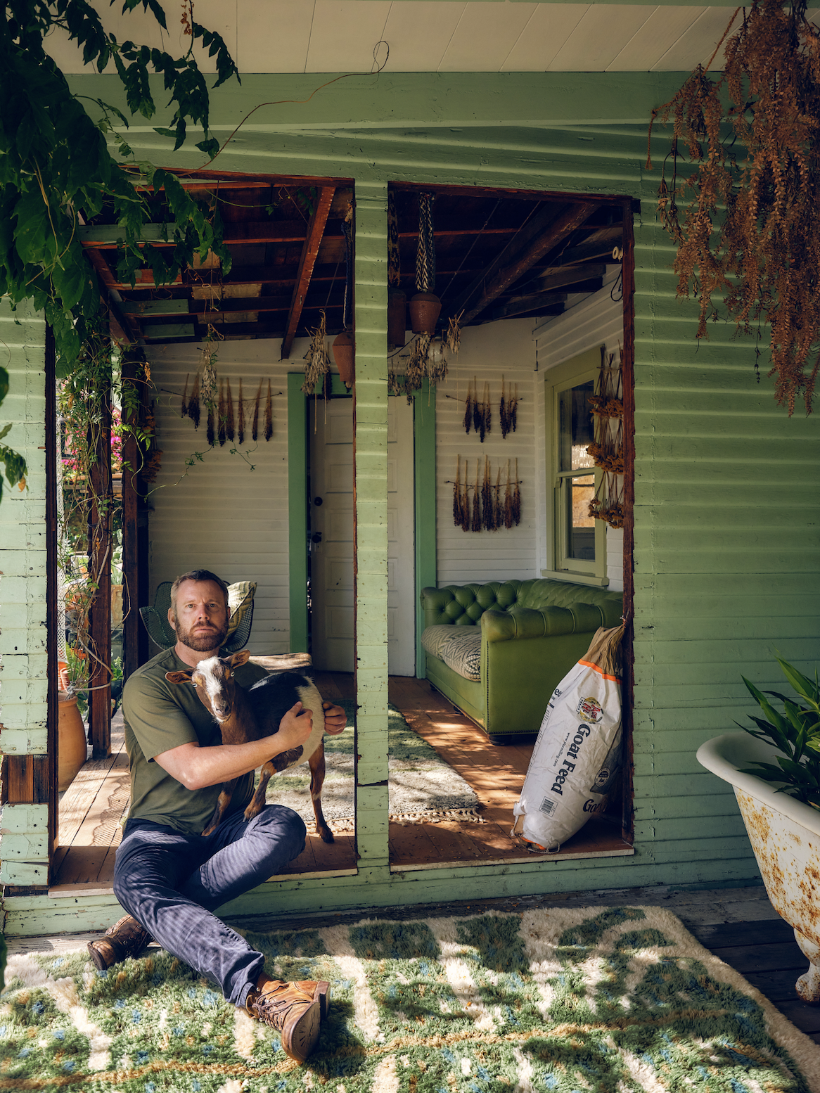 Christiansen at home with one of his goats. (Photo: Hugh Davison. Courtesy Flamingo Estate)
