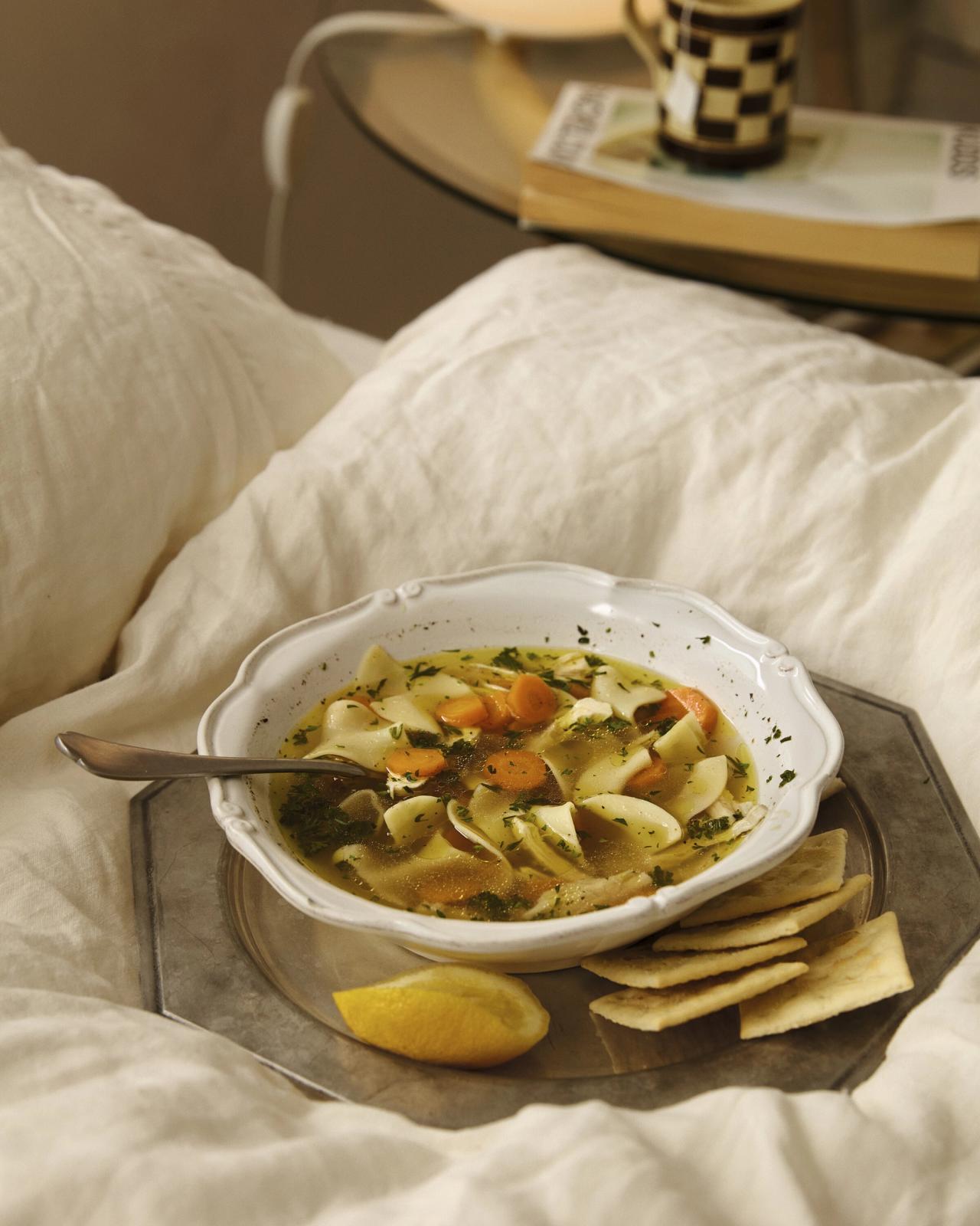 A bowl of Alison's “Chicken Noodle Soup with Lots of Lemon” on her bed, from Something From Nothing. (Photo:Chris Bernabeo)