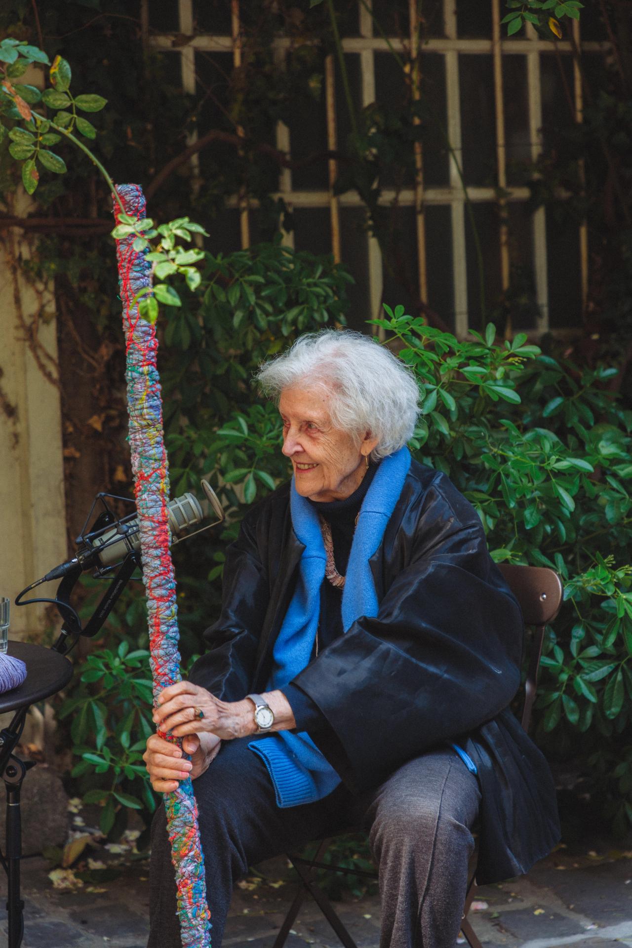 Hicks holding a fabric-and-thread-wrapped stick of her creation during the recording of Ep. 153 of Time Sensitive. (Photo: Agathe Karsenti for The Slowdown)