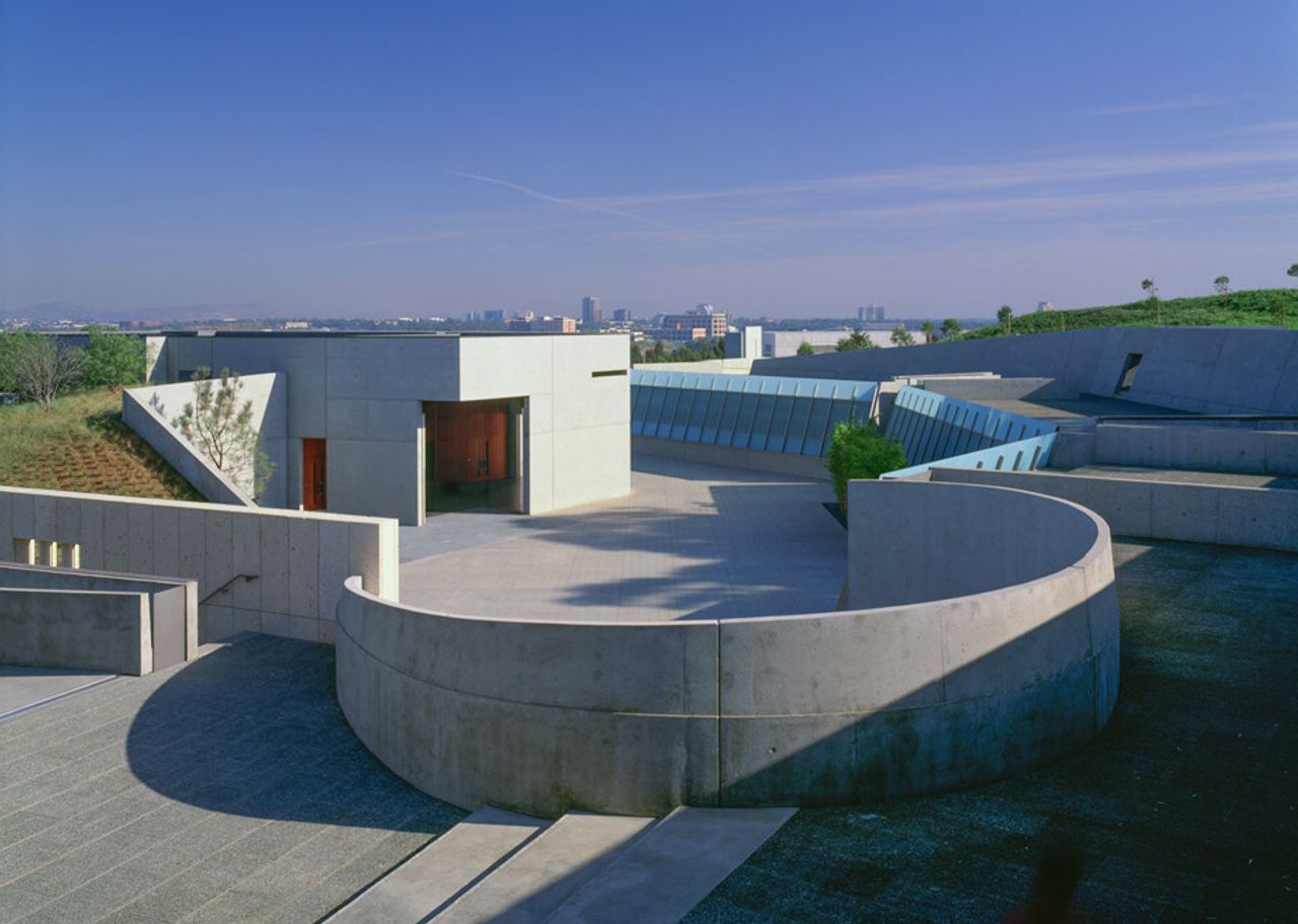 A concrete building with circular fences