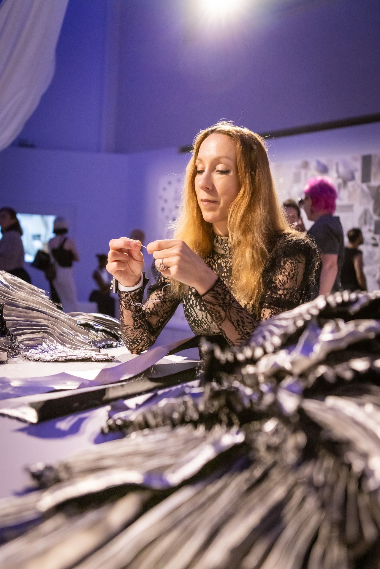 Van Herpen working on a new piece at her recreated atelier as part of her “Sculpting the Senses” exhibition on view at the Brooklyn Museum. (Photo: Steven Sierra)