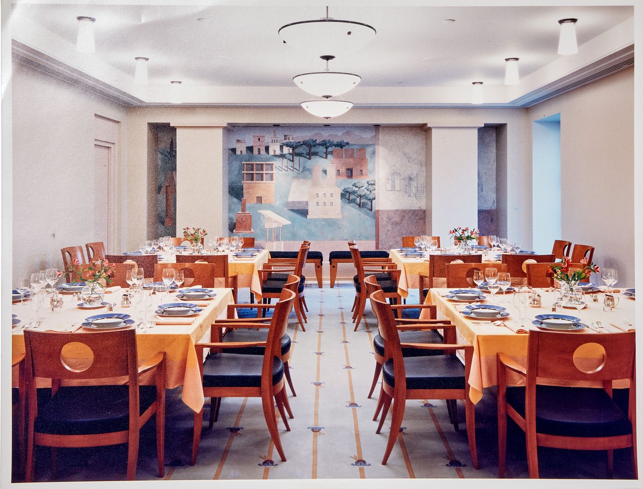The executive dining room in the Crown American Building in Johnstown, Pennsylvania, whose furniture, carpet, place settings, flatware, etc. were all designed by Michael Graves Architecture & Design. The mural in the background is by Michael Graves. (Courtesy John Hoke)