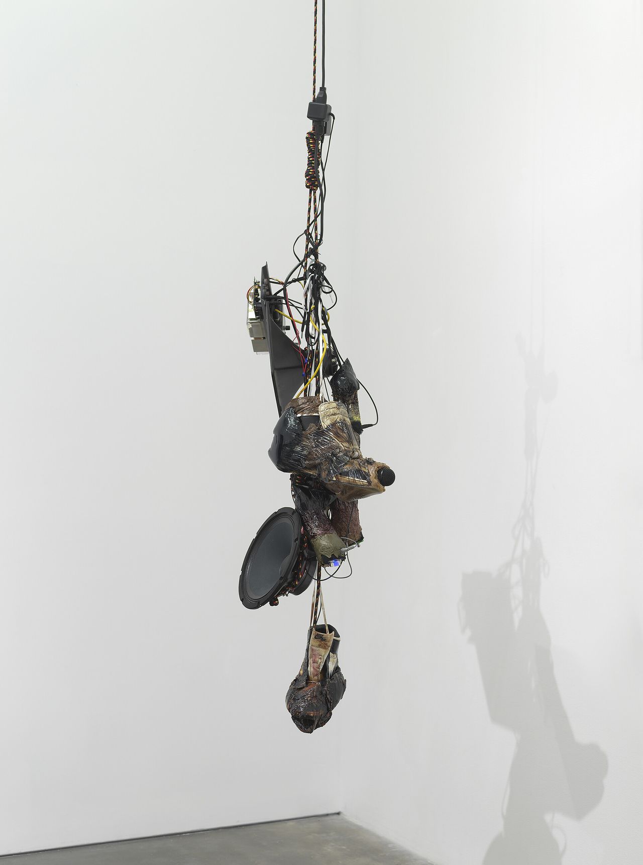 Sneakers and speakers hanging from the ceiling in a bunch