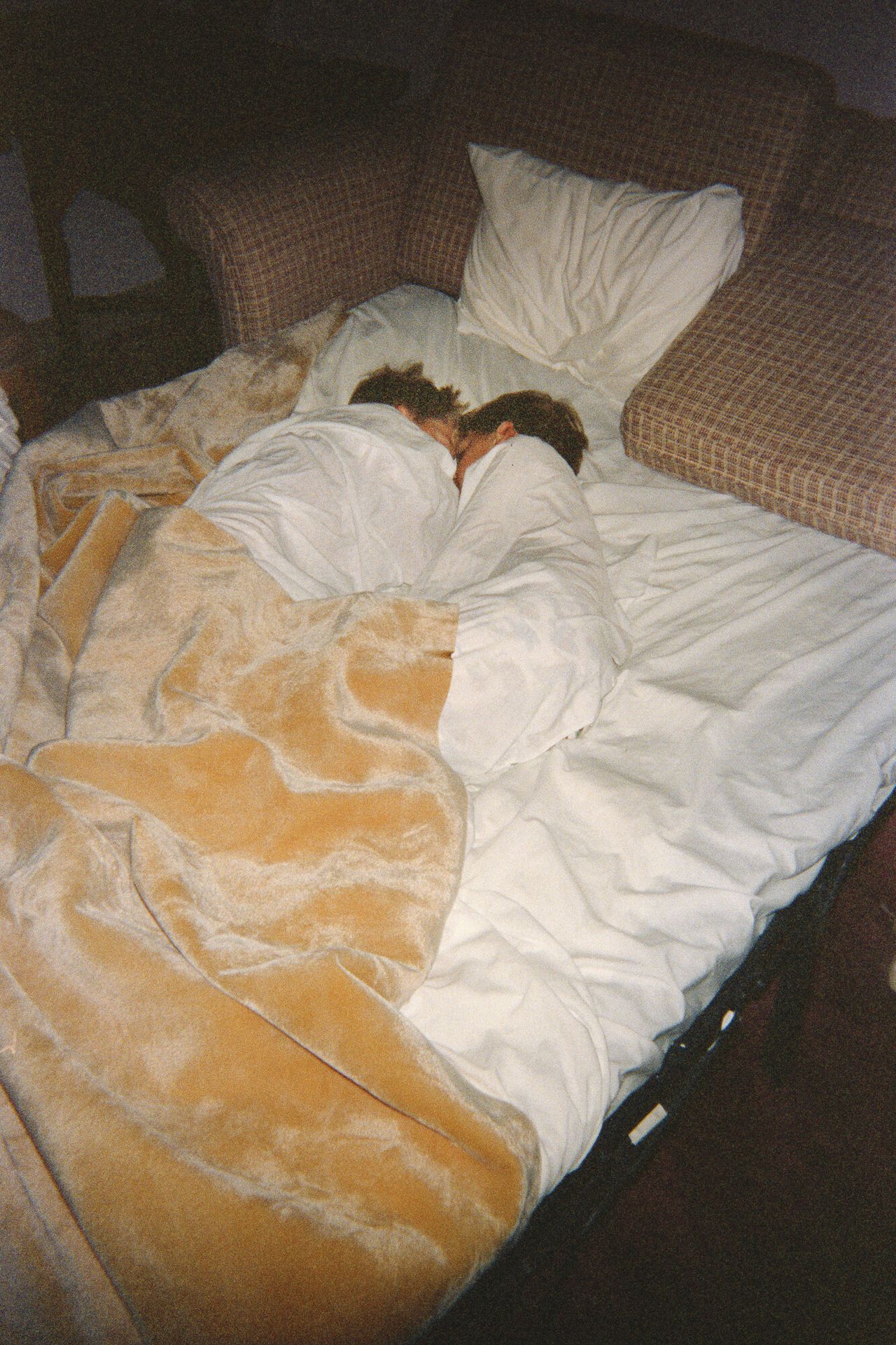 Trent and Spencer asleep together on a pull-out couch during their youth.