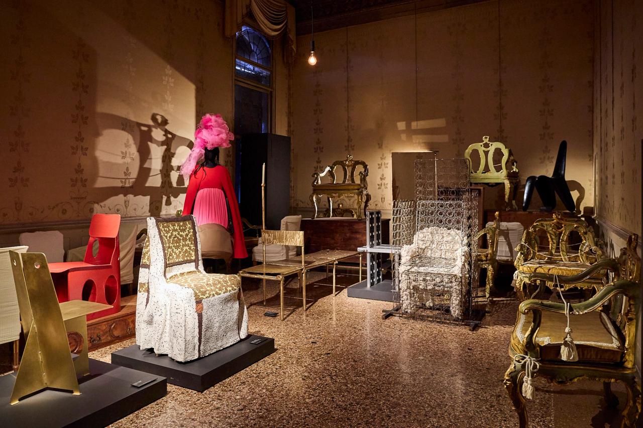 View of the room themed “Chairs: Variations and Deviations.” From left: Lionel Jadot’s “Jam Brass” (2025); Wendy Andreu’s “Empire Ghost Chair” (2024); Seongil Choi’s “Hardened Mesh Chair, Red” (2026); Comme des Garçons headpiece by artist Julien d’Ys (fall/winter 2020); Nifemi Marcus-Bello’s “The Daybed” (2026). Lionel Jadot’s “SLV Chair” (2020); Lionel Jadot’s “Spring Swab” (2020), an old chair used by Jadot’s grandmother to have her morning coffee. (Photo: Antonio Campanella for The Slowdown/Courtesy Objects With Narratives; Courtesy Uppercut; Courtesy Uppercut; Courtesy Comme des Garçons; Courtesy Nifemi Marcus-Bello and Side Gallery; Courtesy Objects With Narratives; Courtesy Galila's Collection, Belgium)