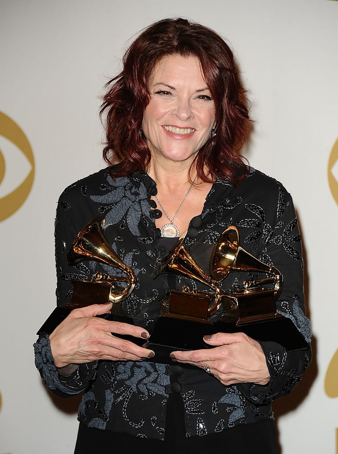 Rosanne Cash holding Grammys