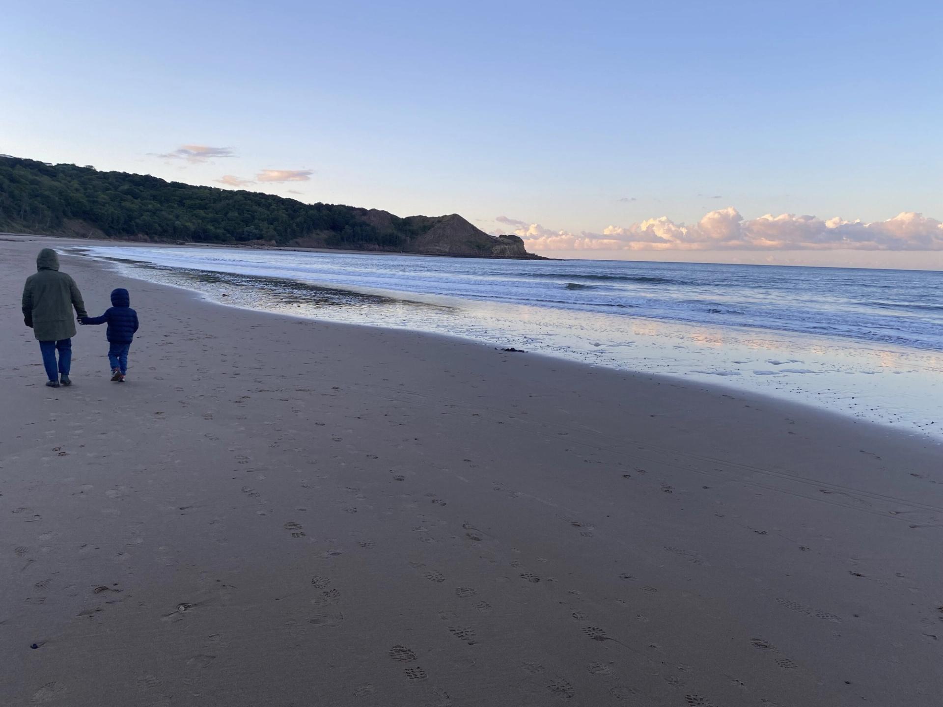 Burkeman's partner and son walking on, as he puts it, “a typically foreboding” Yorkshire beach. (Courtesy Oliver Burkeman)
