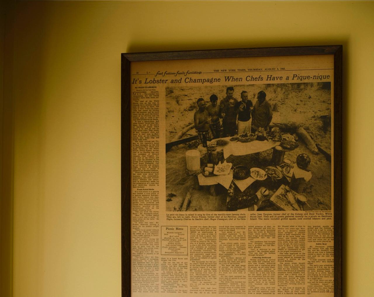 A framed newspaper clipping of a New York Times article about a picnic on Gardiners Island in New York in 1965, organized by Pépin, Pierre Franey, Roger Fessaguet, Jean Vergnes, and René Verdon, among the most acclaimed chefs of their time. (Photo: Matt Harrington for The Slowdown)