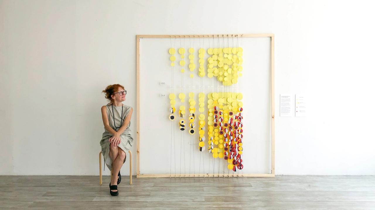 Giorgia Lupi with her piece “Connecting the Dots on Income Inequality” for RAND Art + Data. (Courtesy RAND Art + Data)