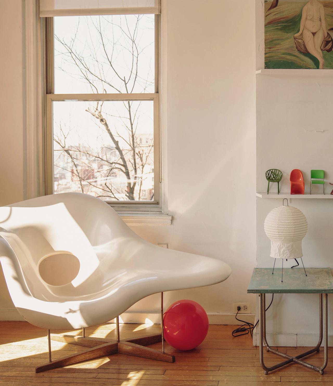 An egg-shaped chair against a window