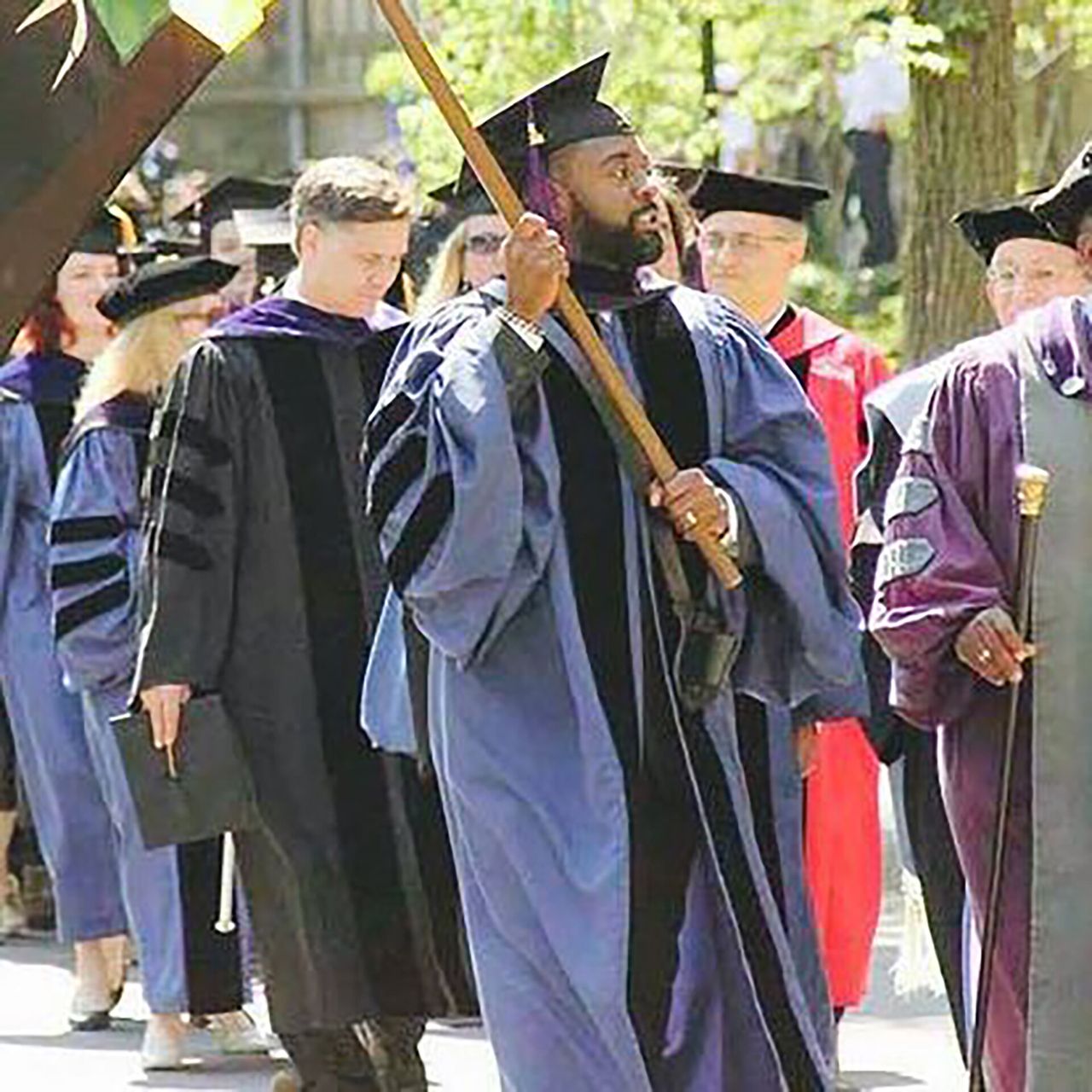 Betts bearing the flag at his graduation from Yale Law School in 2016. (Courtesy Reginald Dwayne Betts)