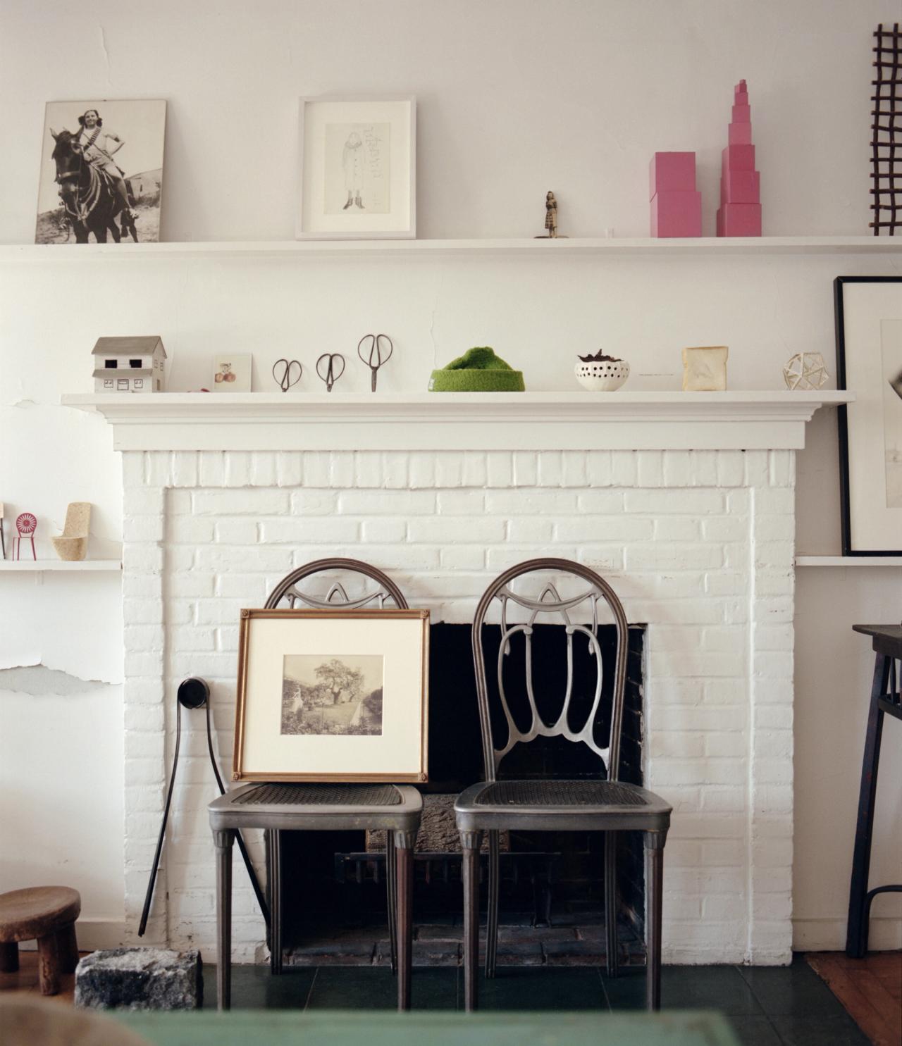 Two chairs against a fireplace