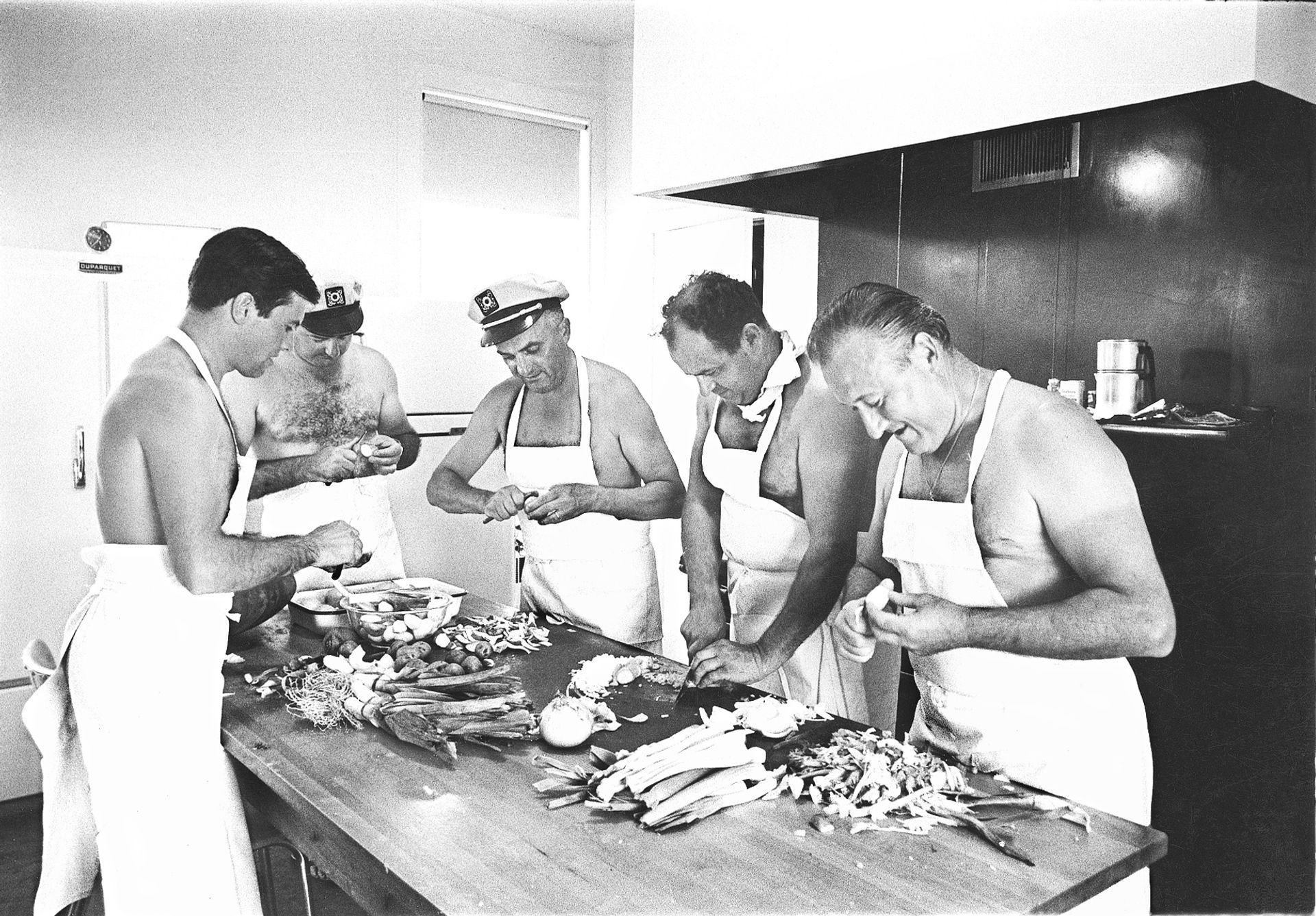 A young Pépin preparing for a party organized by the New York Times food editor Craig Claiborne in his East Hamptons kitchen in 1965. With Pépin (L-R): Roger Fessaguet, chef at La Caravelle; Pierre Franey, chef at Le Pavillon; Réné Verdon, chef at the Kennedy Whitehouse; and Jean Vergens, chef at Le Colony. (Courtesy Jacques Pépin)