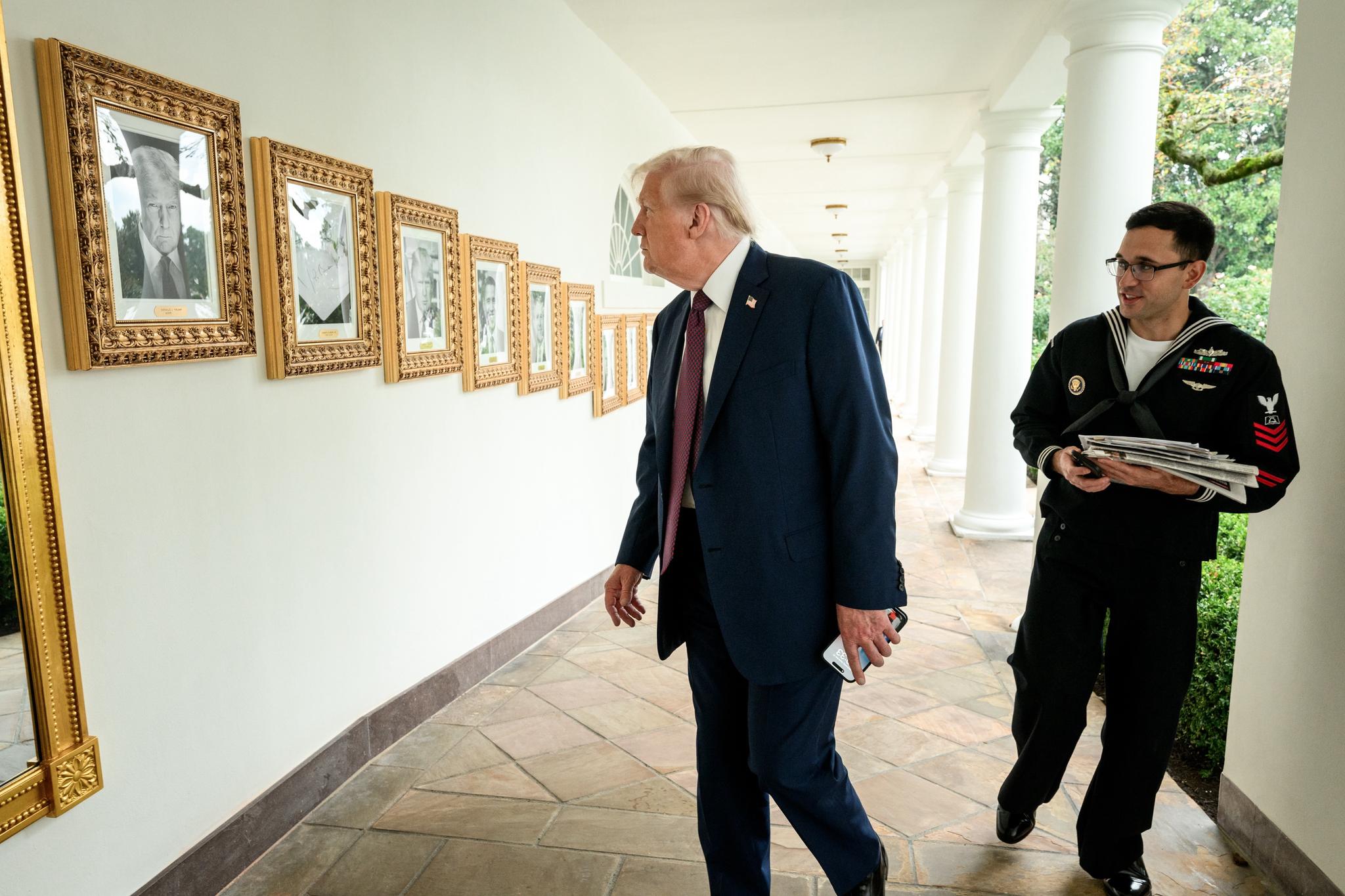President Donald Trump views Biden’s “portrait” on the Presidential Walk of Fame.