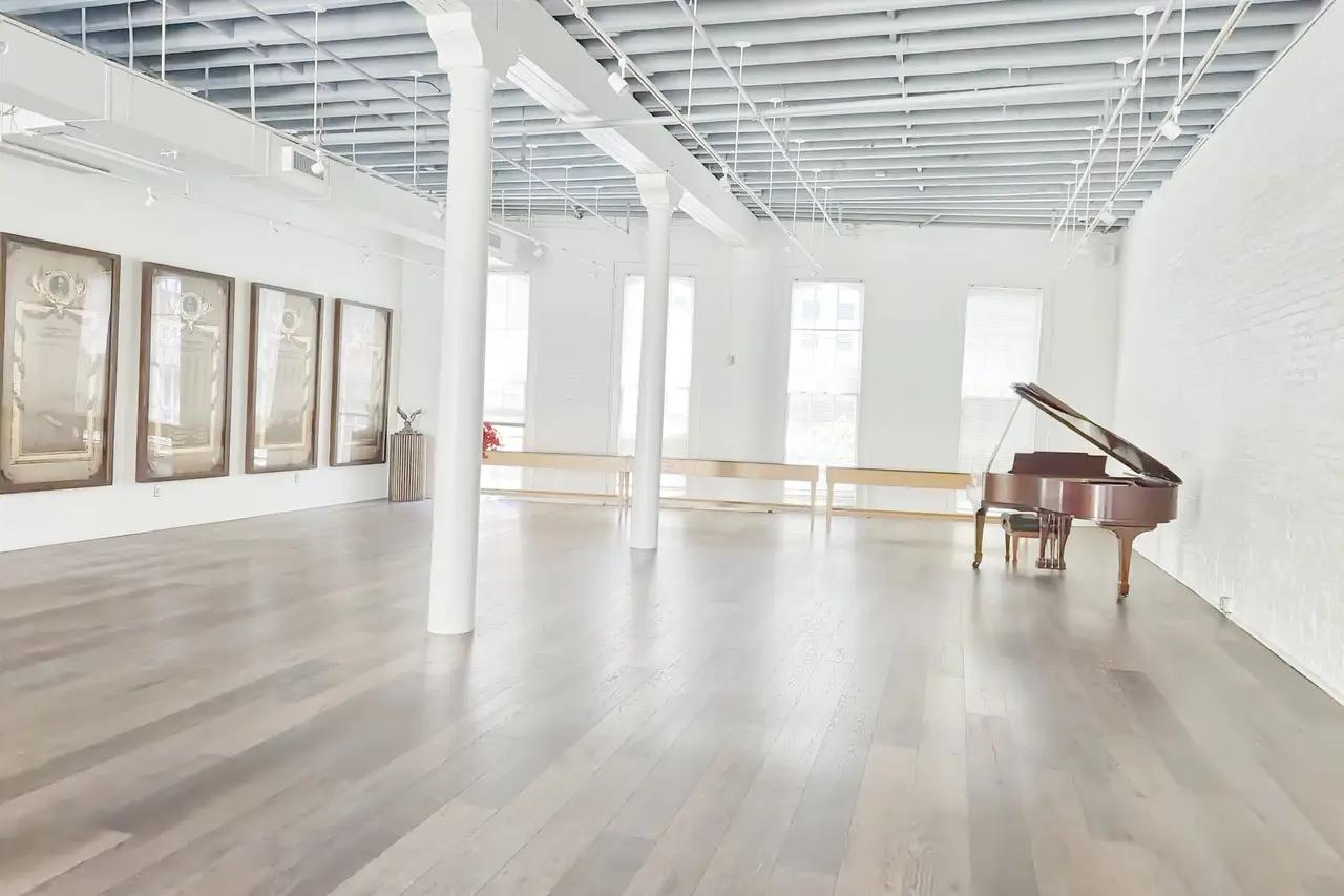 there is a piano in the middle of the room.