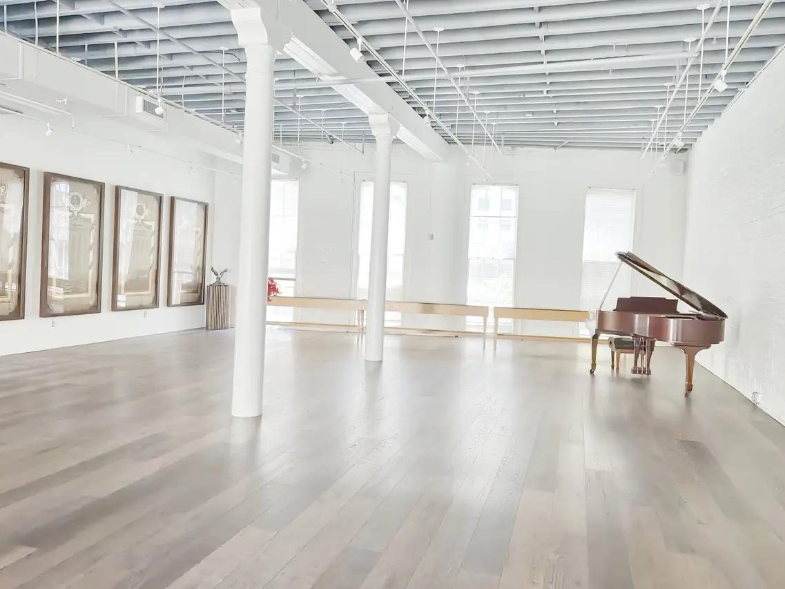 there is a piano in the middle of the room.