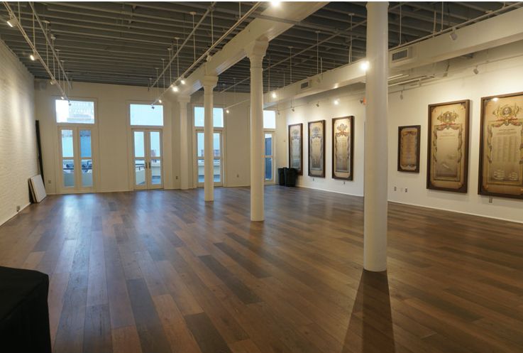 a large empty room with hardwood floors and white walls .