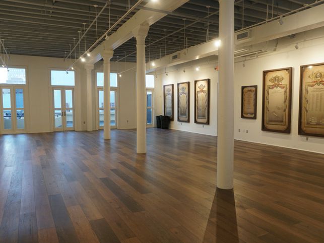 a large empty room with hardwood floors and white walls .