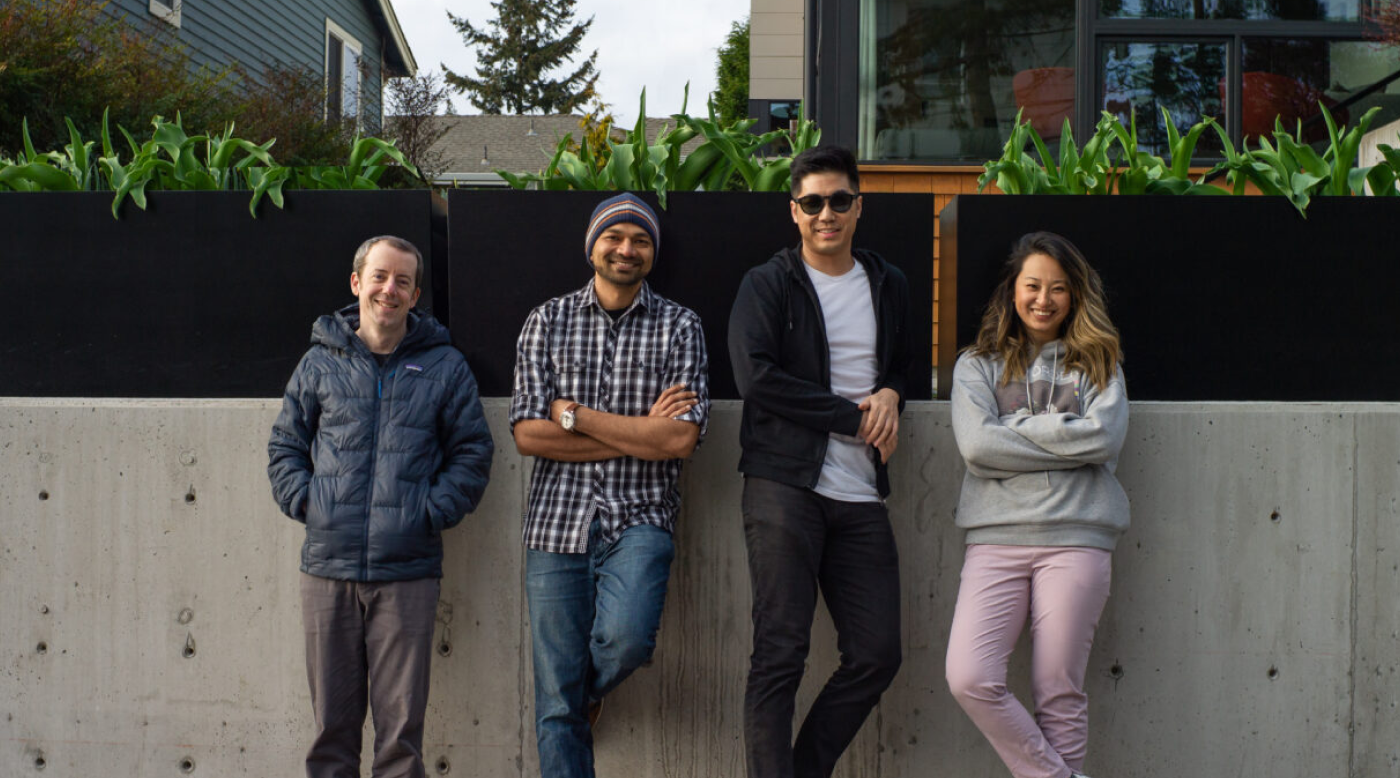 Photograph of Common Room founders standing against a wall.
