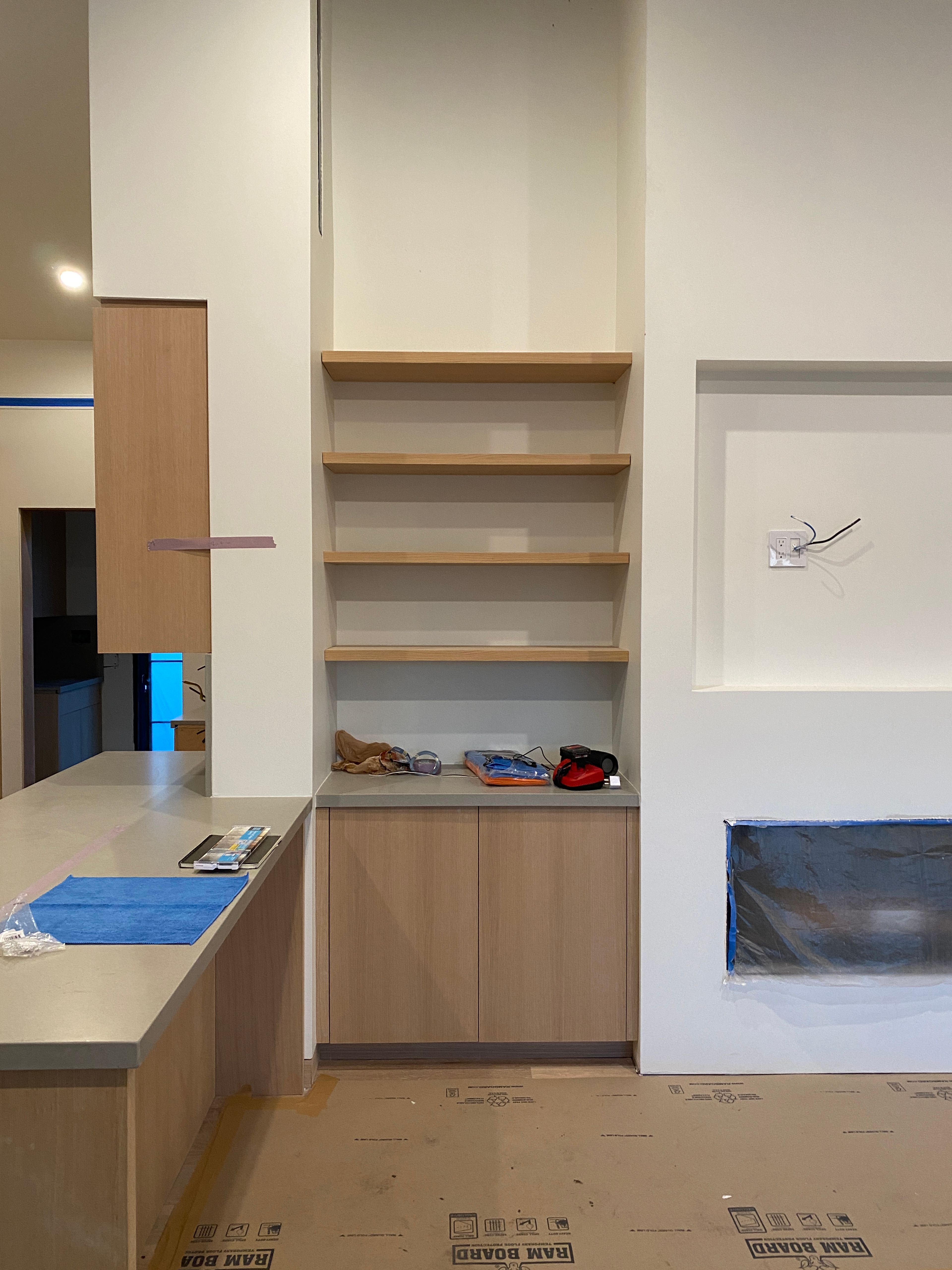 Built-in white oak shelving next to the fireplace