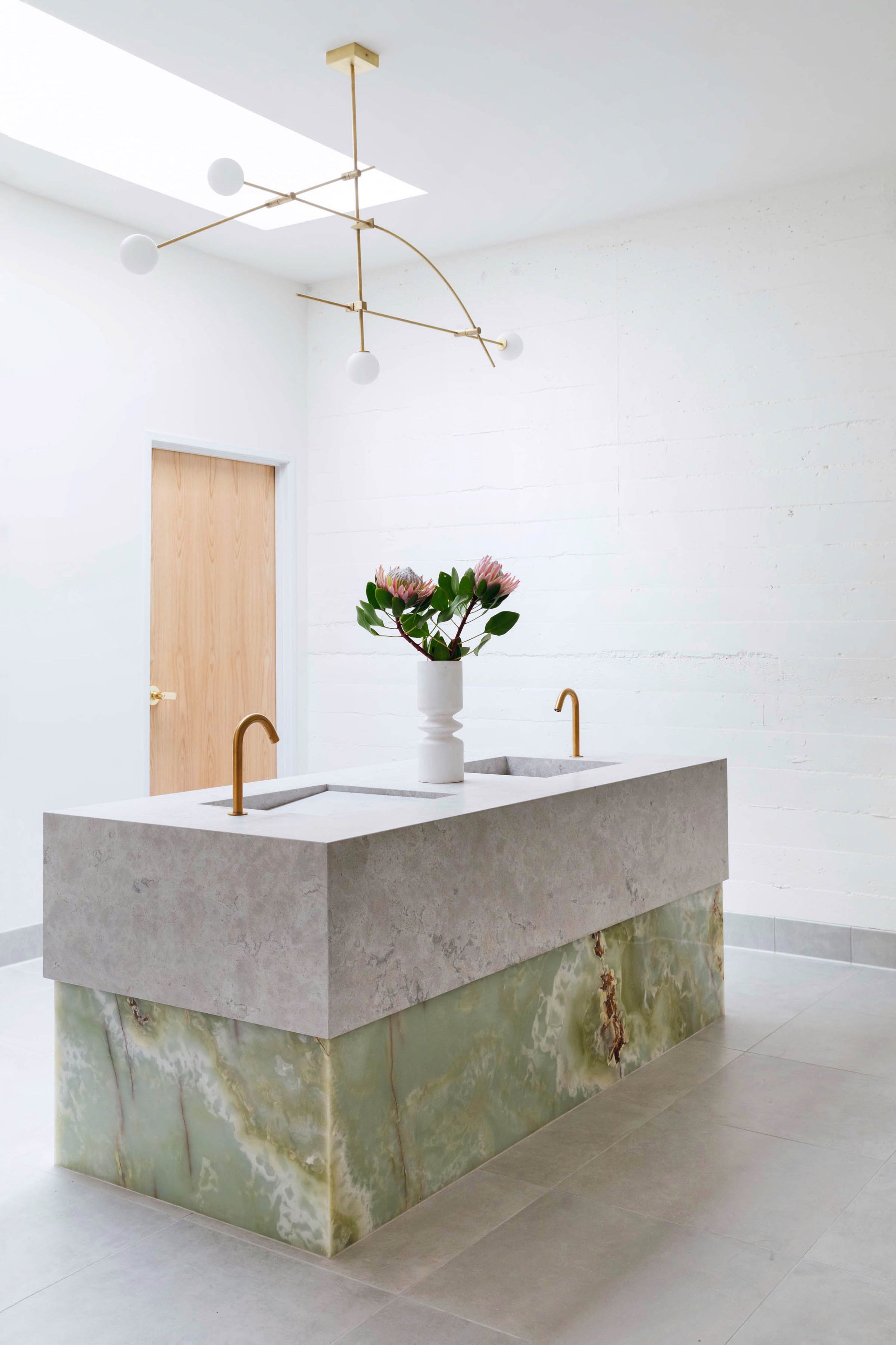 Light by Atelier de Troupe above the custom vanity.