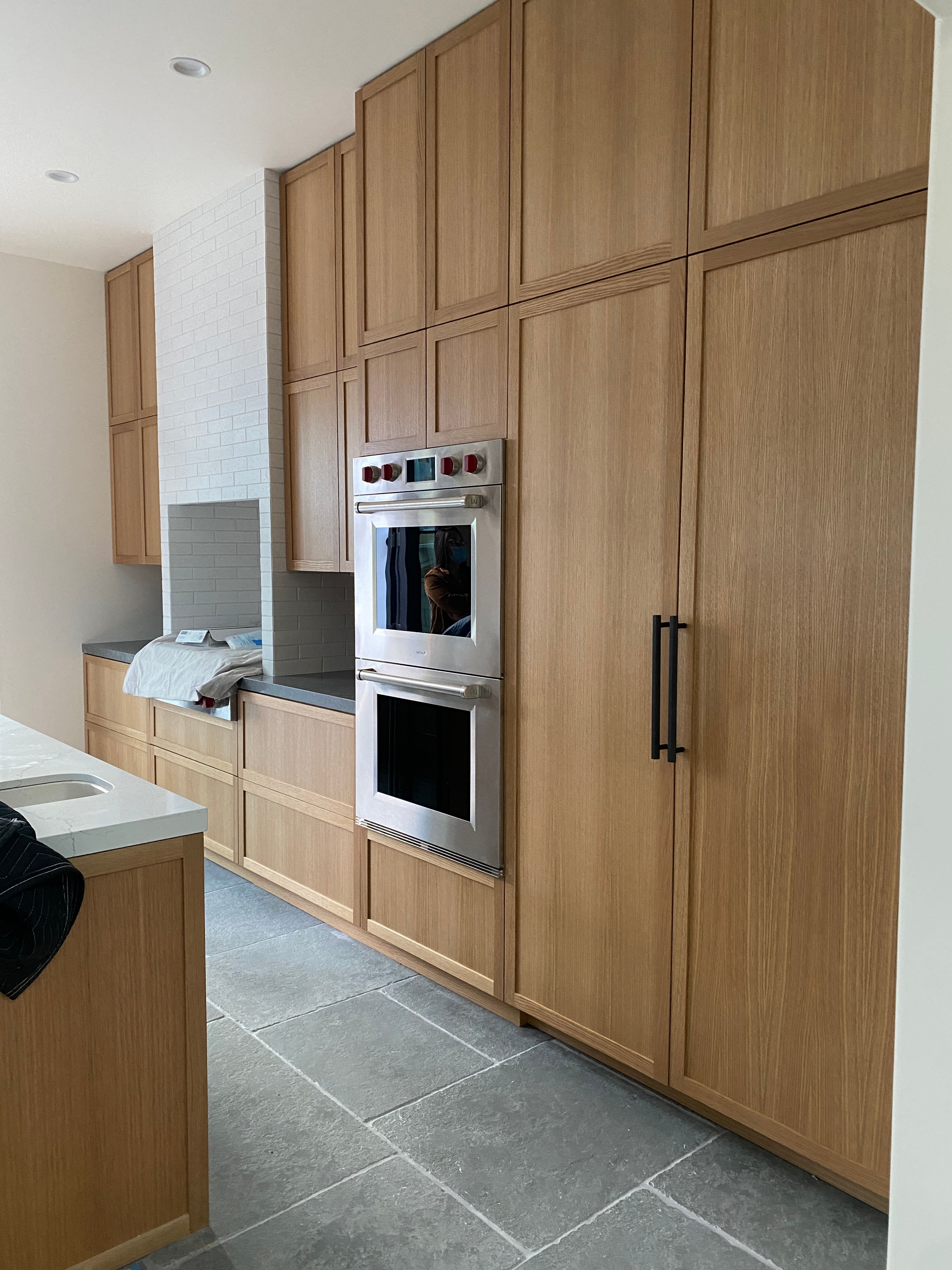 White oak's gorgeous grain is highlighted on these large Shaker style doors