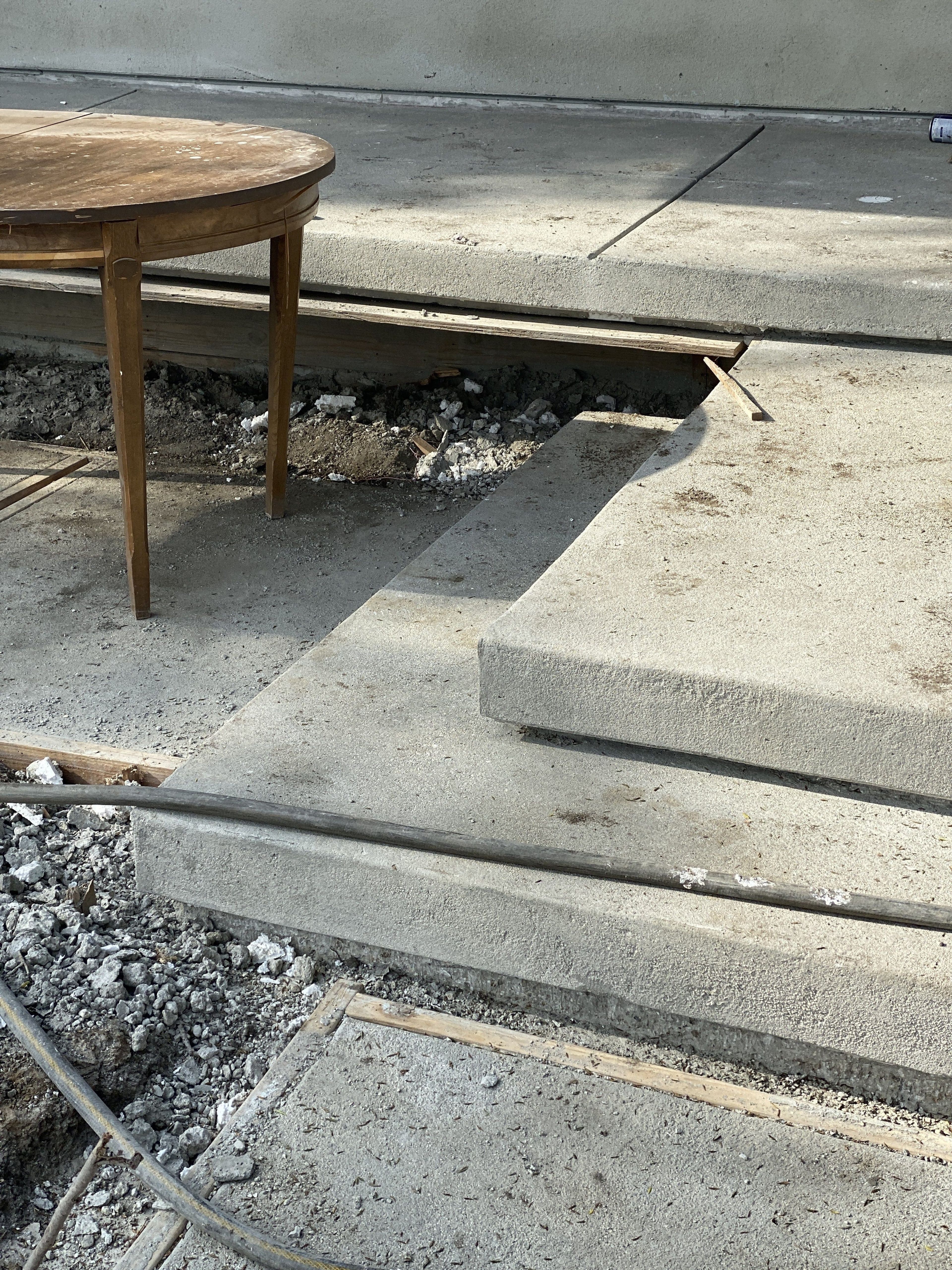 Each step has a 2-inch recess at the bottom thin and deep enough for light and shadow break apart a monolith.