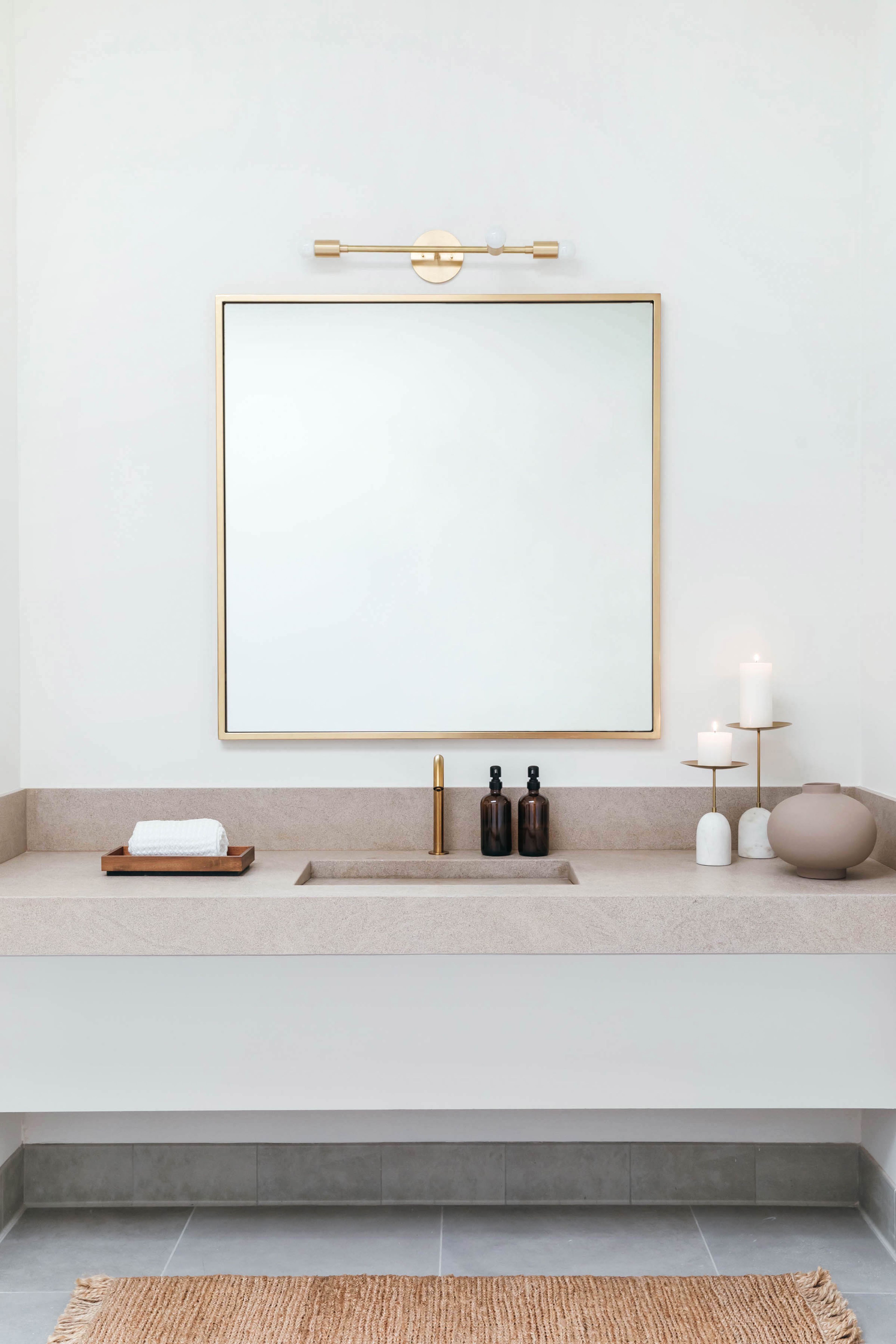Limestone vanity. Light by Park Studio.