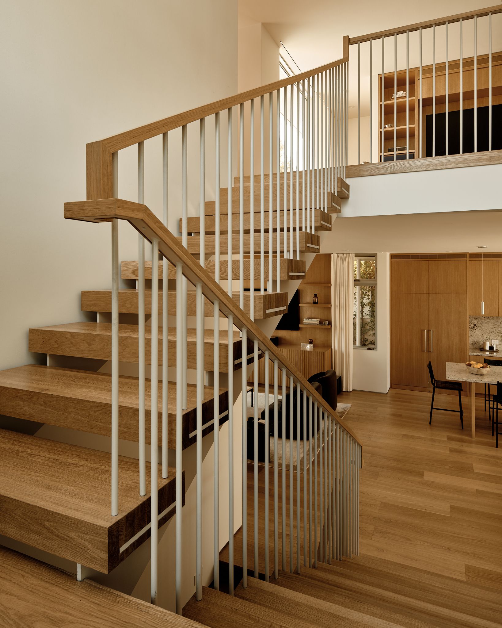 A guardrail made of a combination of custom painted steel and white oak 